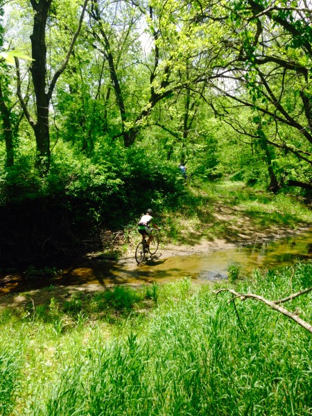 Brian riding across a small stream.  I didn't have to dismount the whole time.  I was wearing my carbon road shoes.