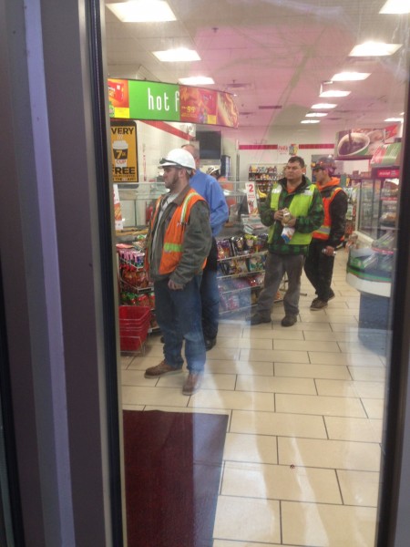 The construction workers were lining up to get lunch in a 7-11.  I've never considered eating lunch there.  Most were getting either a slice of pizza or hotdog, along with a Rockstar or other energy drink.  Strange.