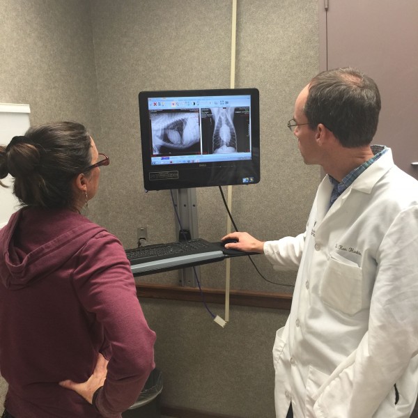 Dr. Harkin explaining to Trudi the chest x-rays.