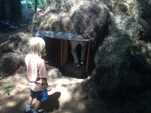 And his child watching Catherine go into a hay hut he built.
