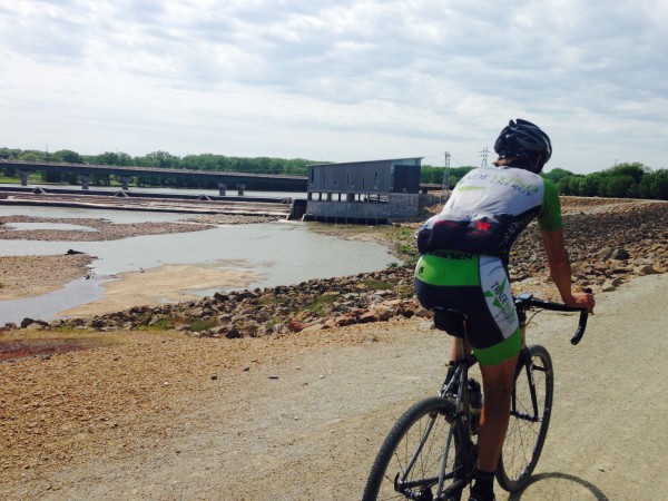 Brian riding into Lawrence on the levee.   They are building a new hydro electrical plant there now.
