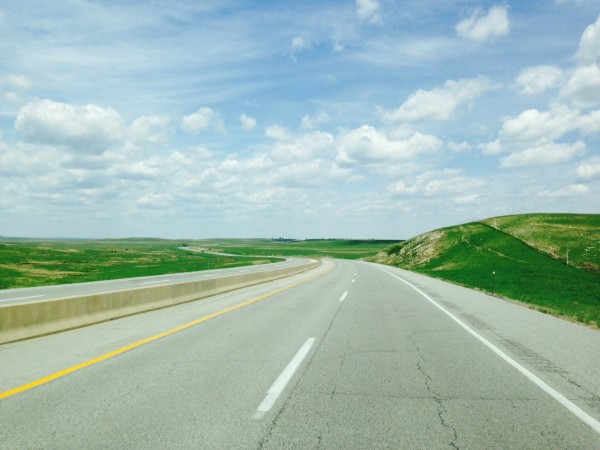 The grass on both sides of the road in the Flint Hills is pretty green.