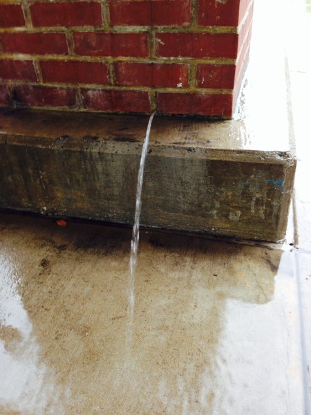 Water was pouring out of a pillar at a local shopping mall.  I have no idea what the problem is to have this brick column full of water, but something is really wrong.