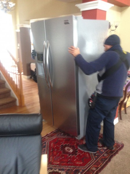 They got a new refrigerator this morning.  The moving guys just used a strap over their shoulders to move the old one out and new one back in.  Pretty cool.