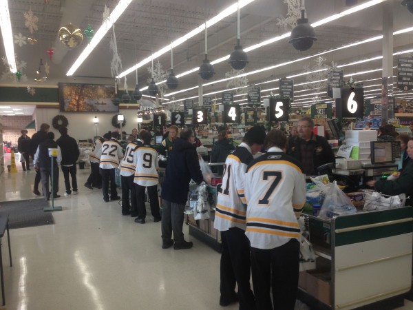 The highschool hockey team was bagging groceries at the local grocery store in Hayward last night.