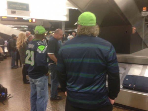Waiting for luggage last night, everyone is dressed in Seahawk colors.