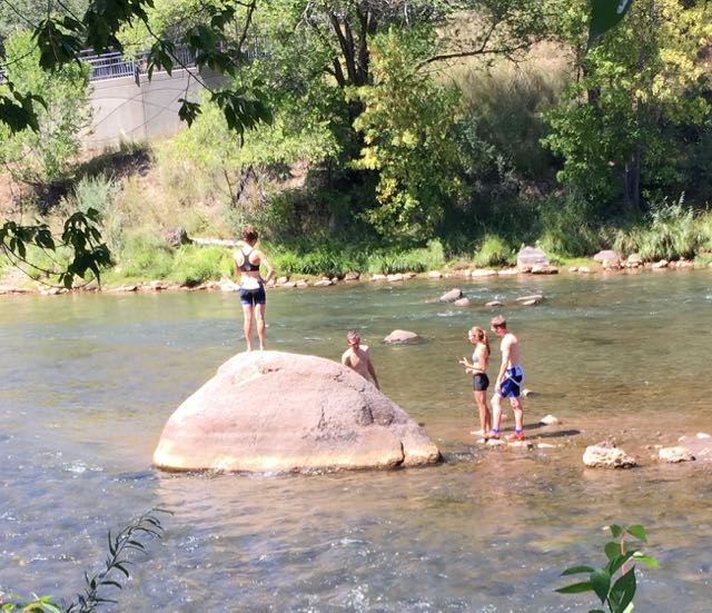 The Endersbe kids, Carley and Libbey, after the ride, enjoying the Animas River. They go to school at Fort Lewis.