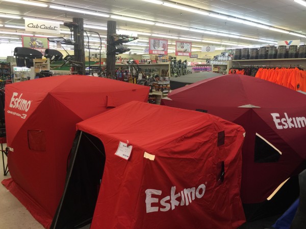 Ice fishing tents, with deer stands behind.