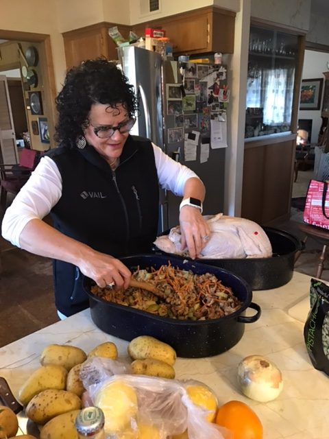 Stacie putting stuffing in the turkey.